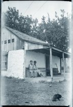 Two unidentified men sitting on a porch, Puuiki, Maui.